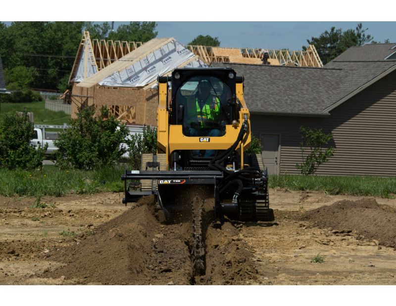Cat® 259D Compact Track Loader and T9B Trencher Attachment Digging a Trench