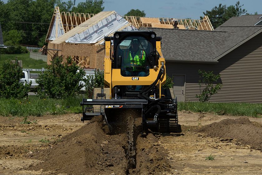 Cat® 259D Compact Track Loader and T9B Trencher Attachment Digging a Trench