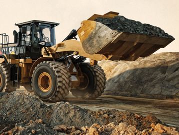 Wheel loader hauling a bucket full of dirt
