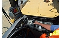 Operator using the Cat Water Delivery System integrated cab controls and electronics in a water truck at the Tuscon Proving Ground (TPG)