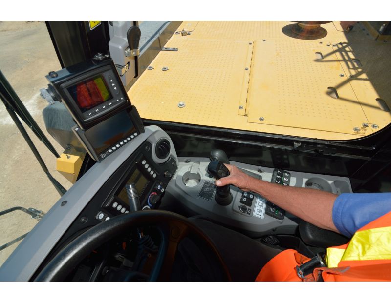 Operator using the Cat Water Delivery System integrated cab controls and electronics in a water truck at the Tuscon Proving Ground (TPG)