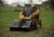 Cat® Landscape Rake on a 259D Compact Track Loader