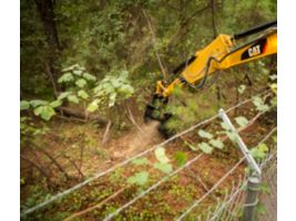 Cat® HM210 Mulcher Clearing Brush on Over a Fence