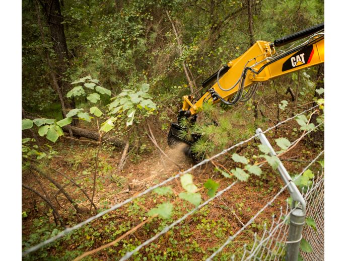 Cat® HM210 Mulcher Clearing Brush on Over a Fence