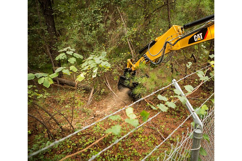 Cat® HM210 Mulcher Clearing Brush on Over a Fence