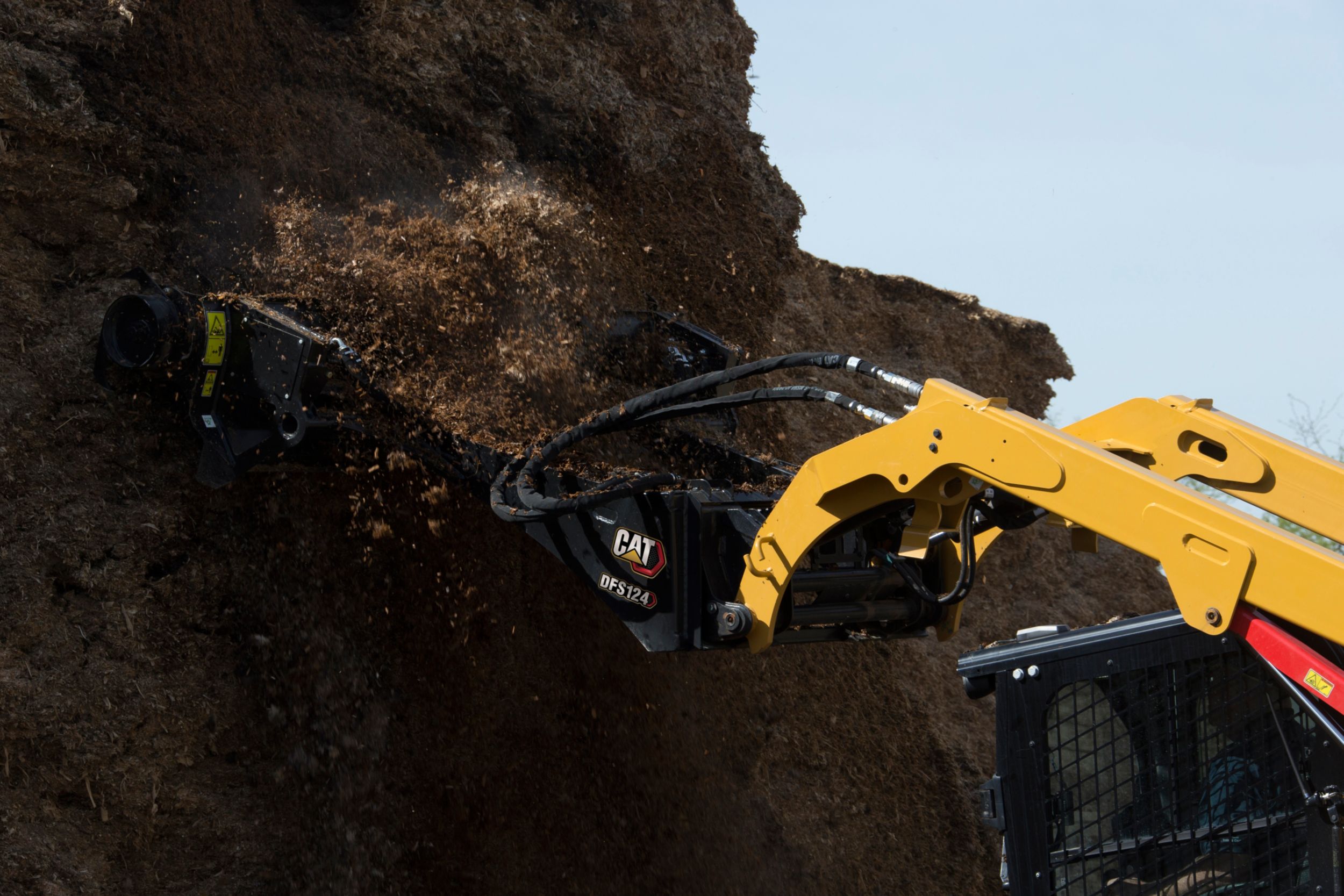 product-Cat® DFS124 Silage Defacer Reaching High in the Pile