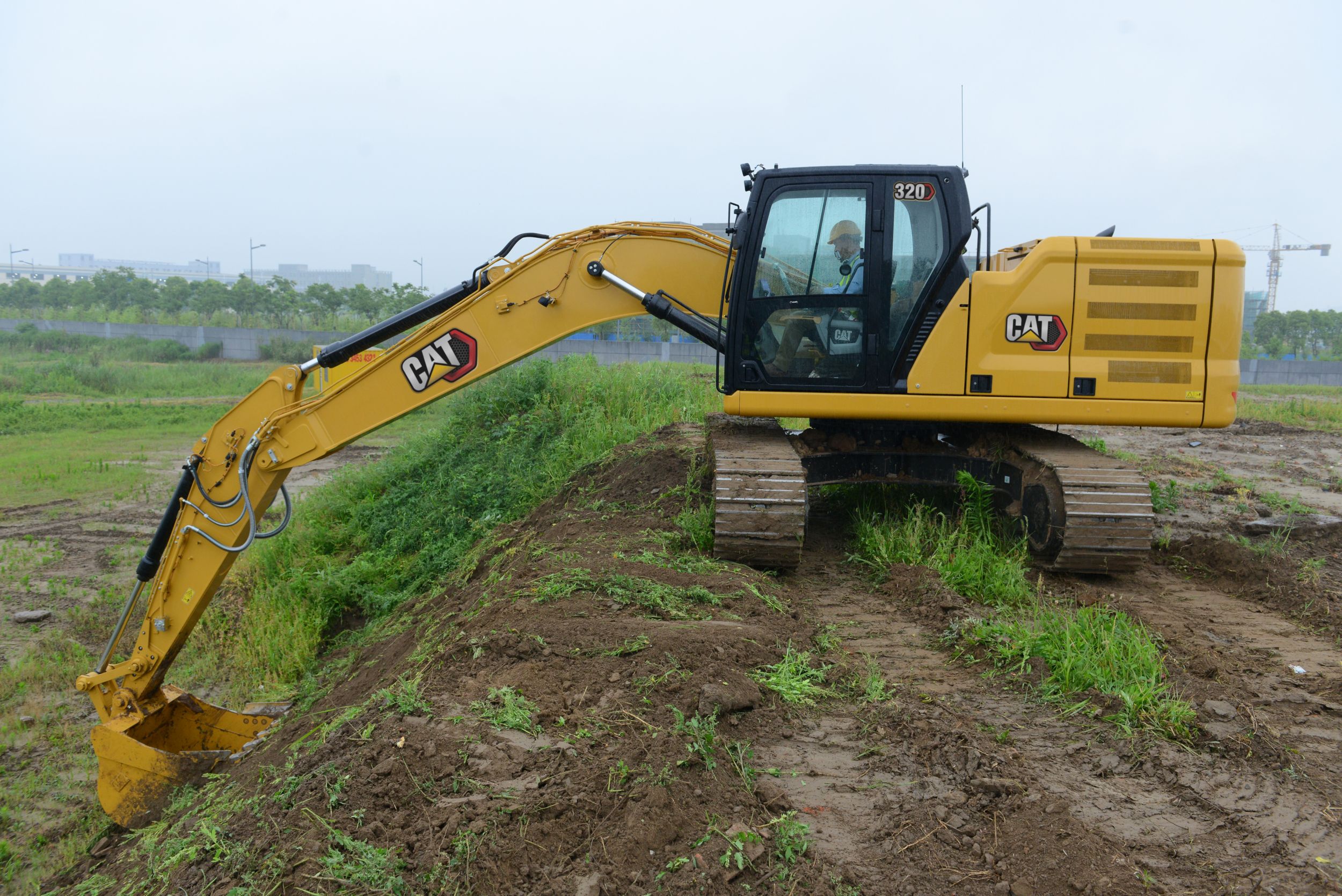 320 Excavator Grading a Hill