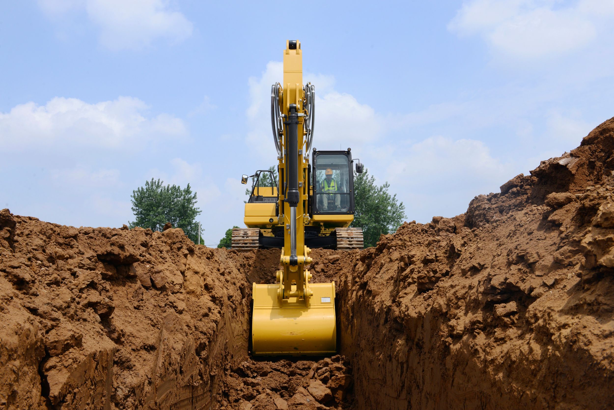 320 Excavator Digging a Trench