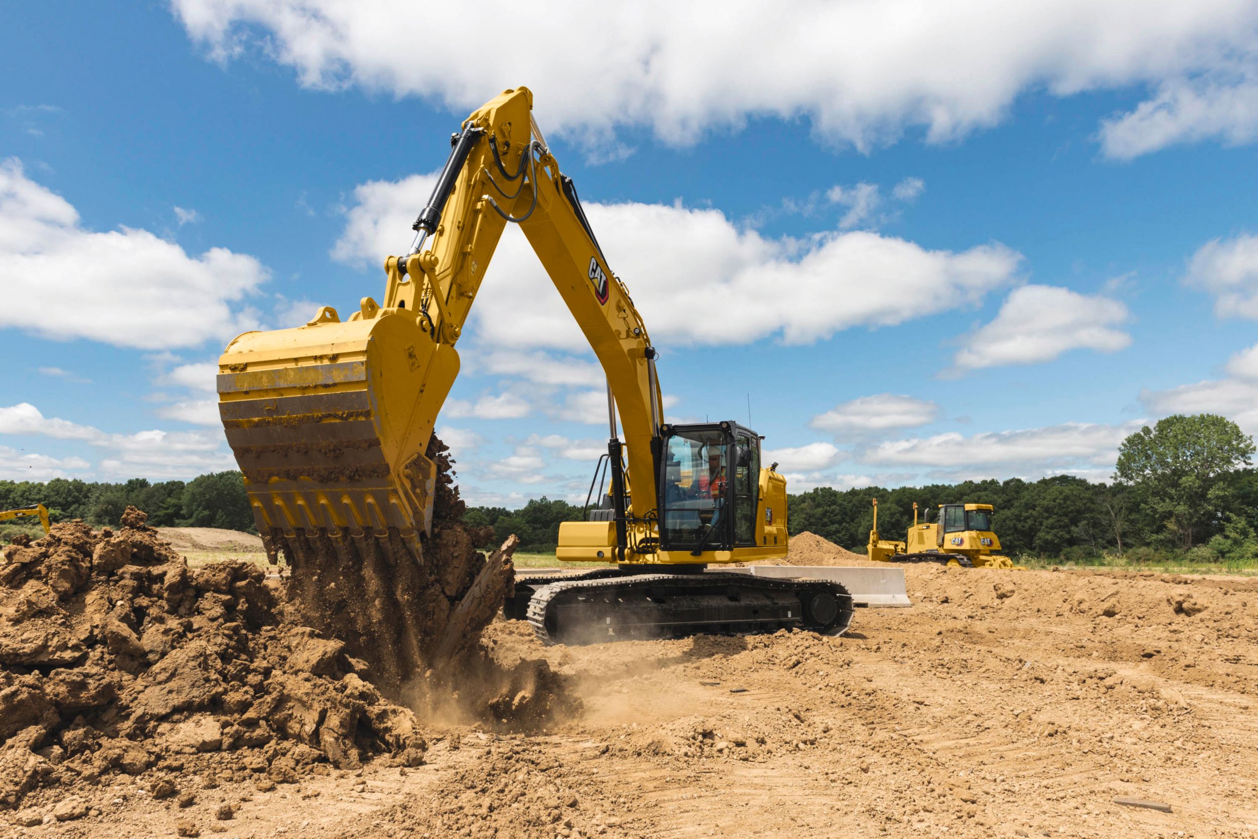 320 Medium Hydraulic Excavator dumping dirt