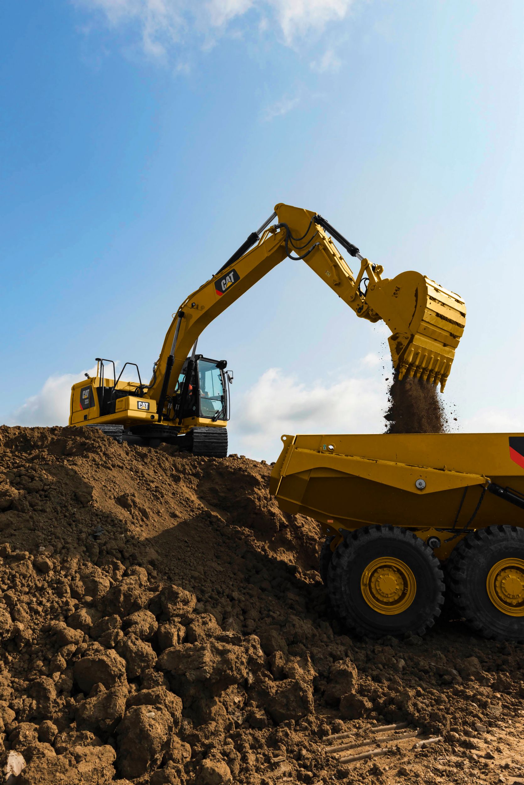 323 Excavator Loading an Articulated Truck