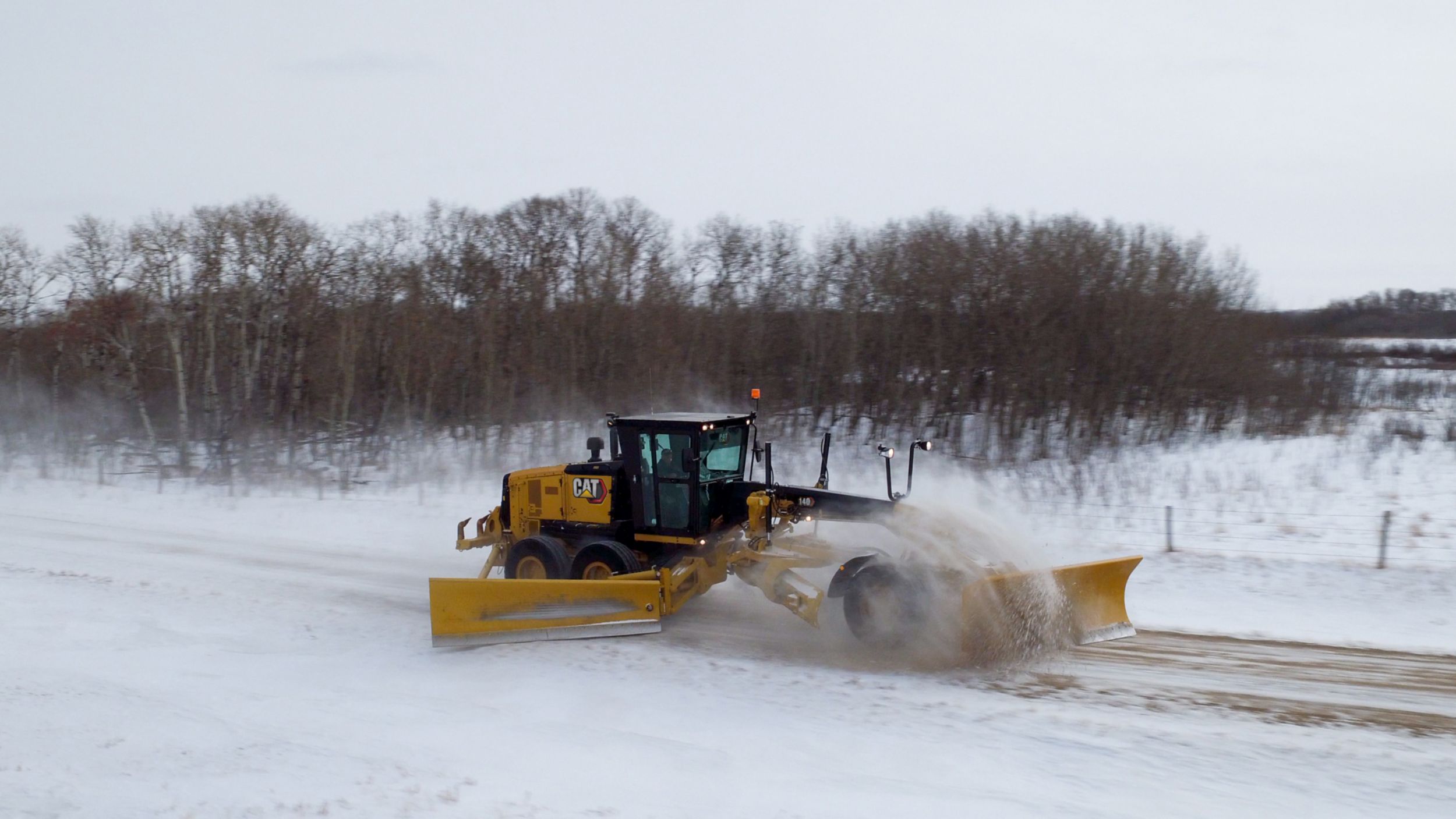 140 Motor Grader plowing with snow wing