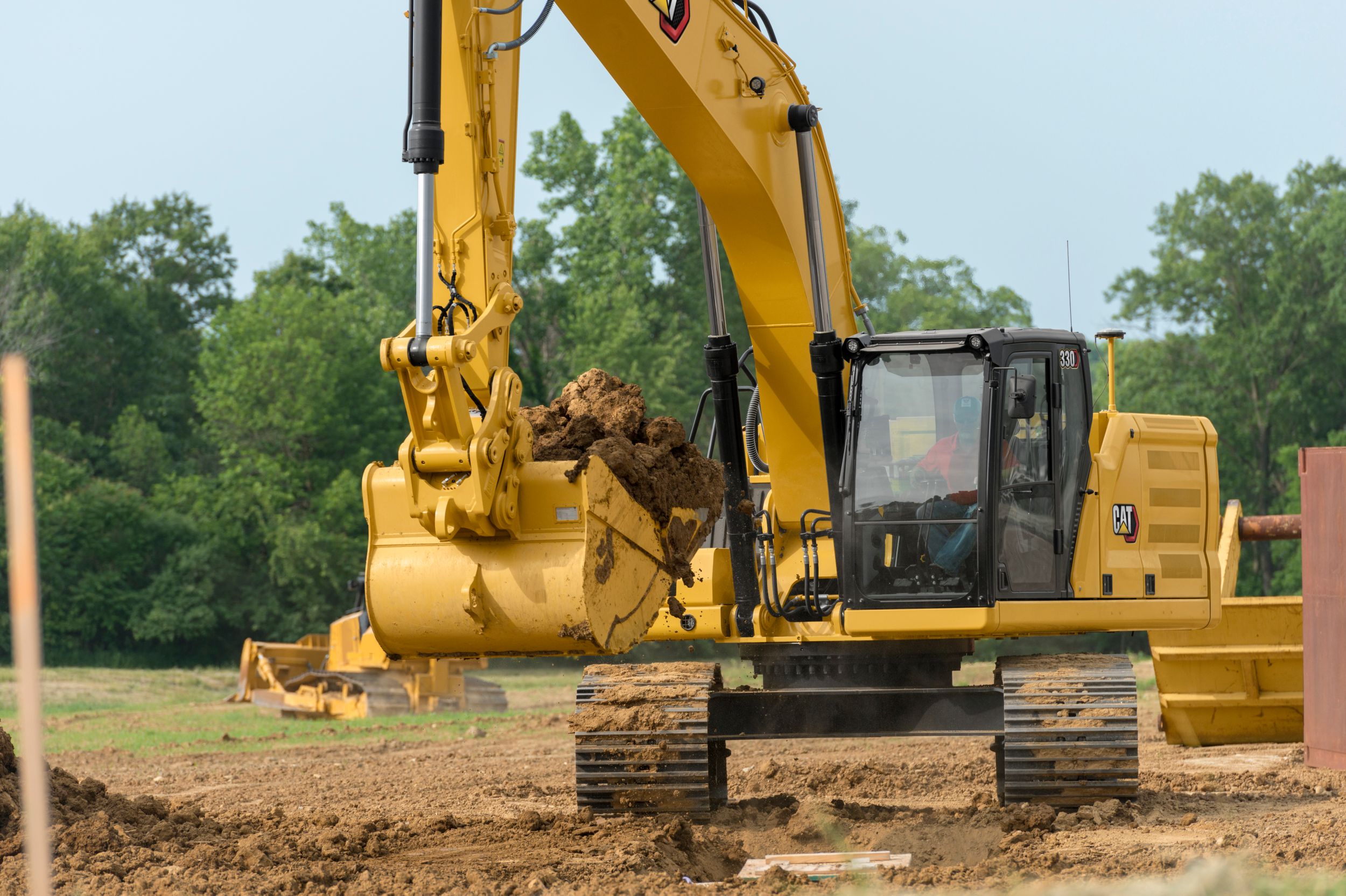 330 Hydraulic Excavator with full bucket of dirt