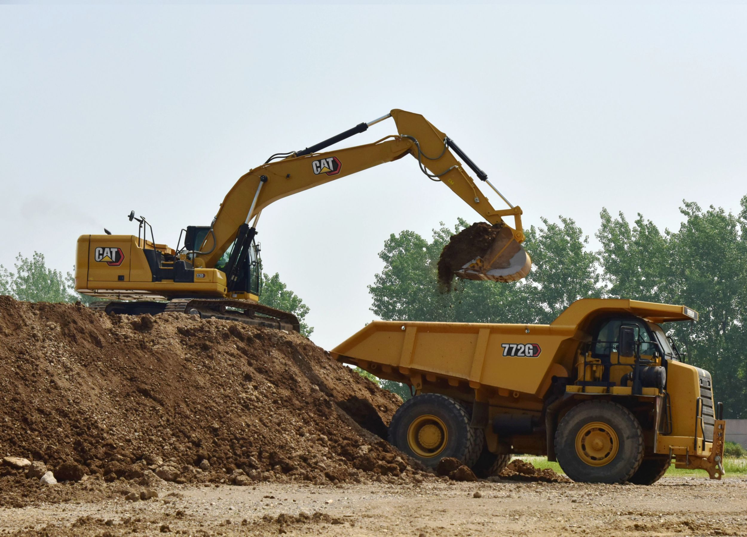 330 Excavator Loading an Off Road Truck