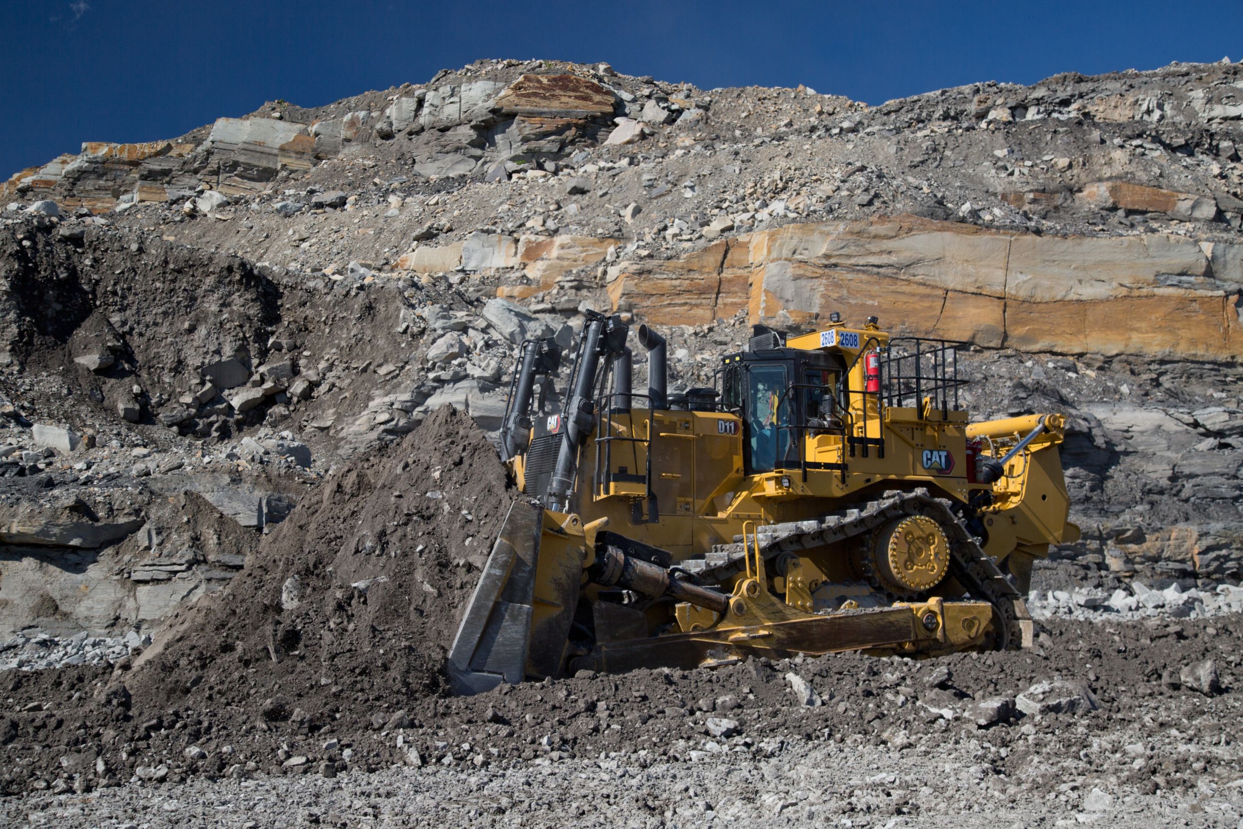 Cat Dozer pushing rock