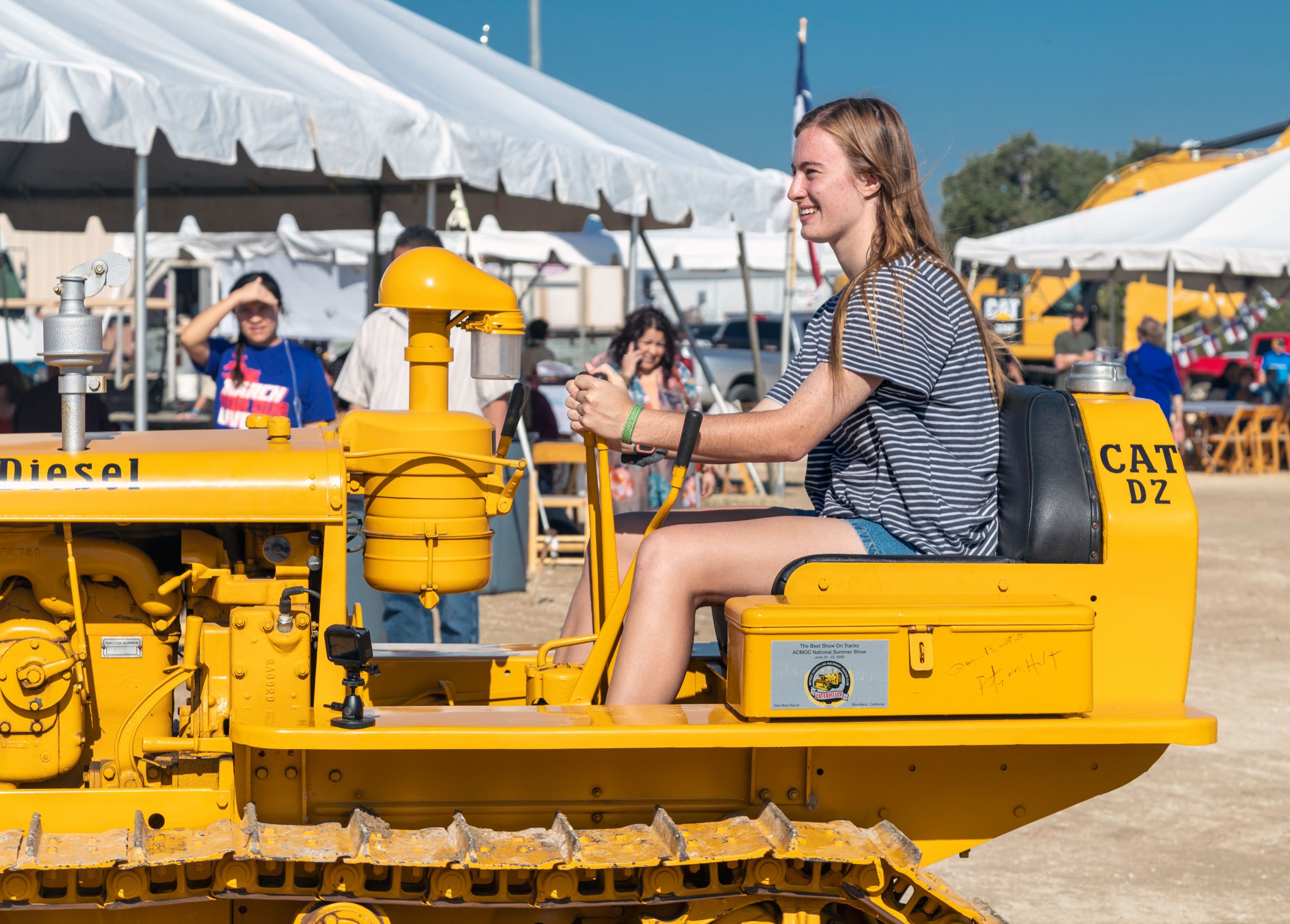 Emily Pfeifer on an antique tractors