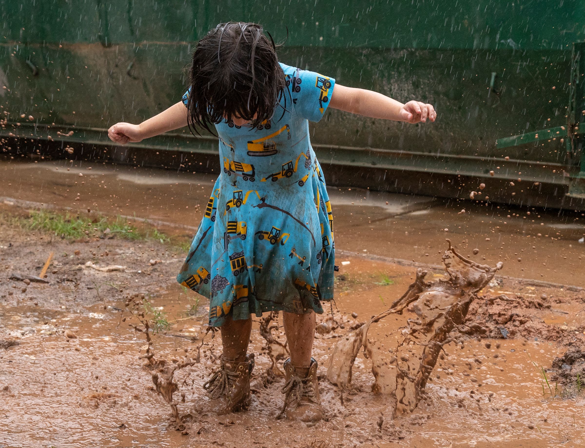 Girl Splashing in Puddle