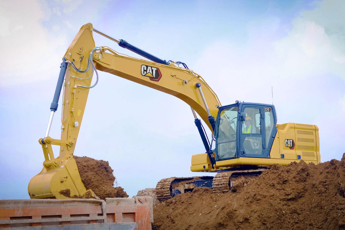 320 Medium Excavator using a General Duty Bucket to load a truck>