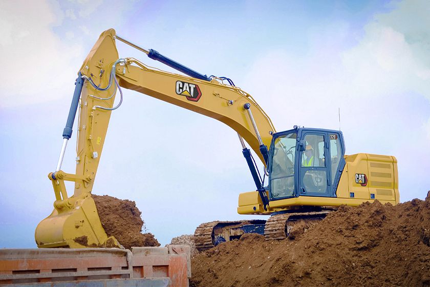 320 Medium Excavator using a General Duty Bucket to load a truck