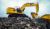 336 Large Excavator loading rock into a truck with a Severe Duty Bucket
