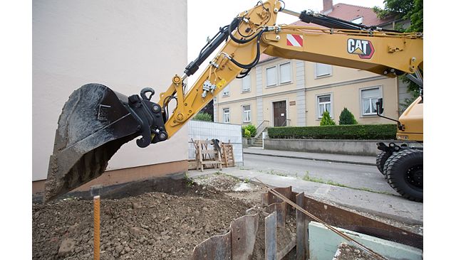 M314 wheel excavator with bucket attachment moving dirt