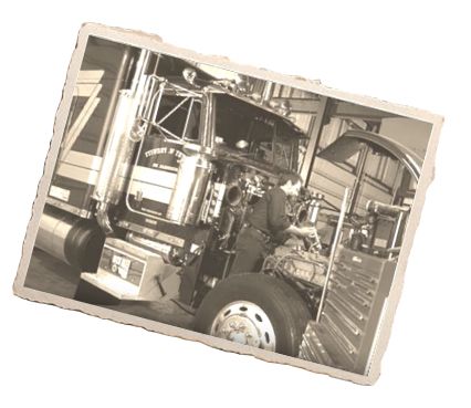 Person working under the hood on truck engine