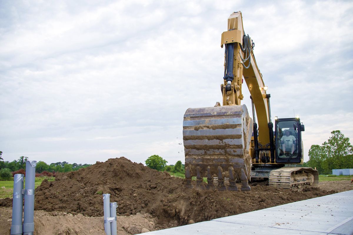 326 Hydraulic Excavator digging a utility trench