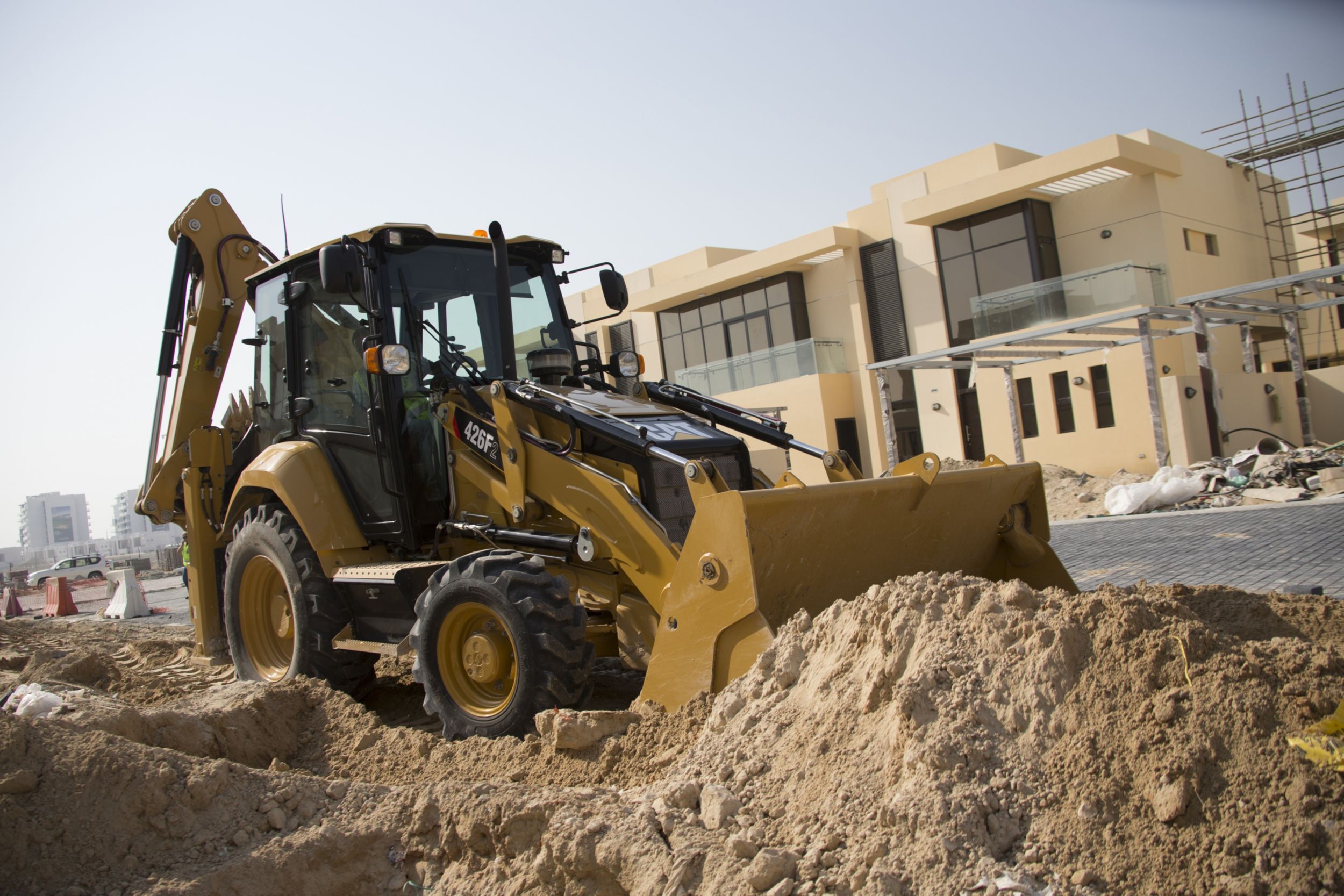 Backhoe Loader Side Shift machine with bucket of dirt