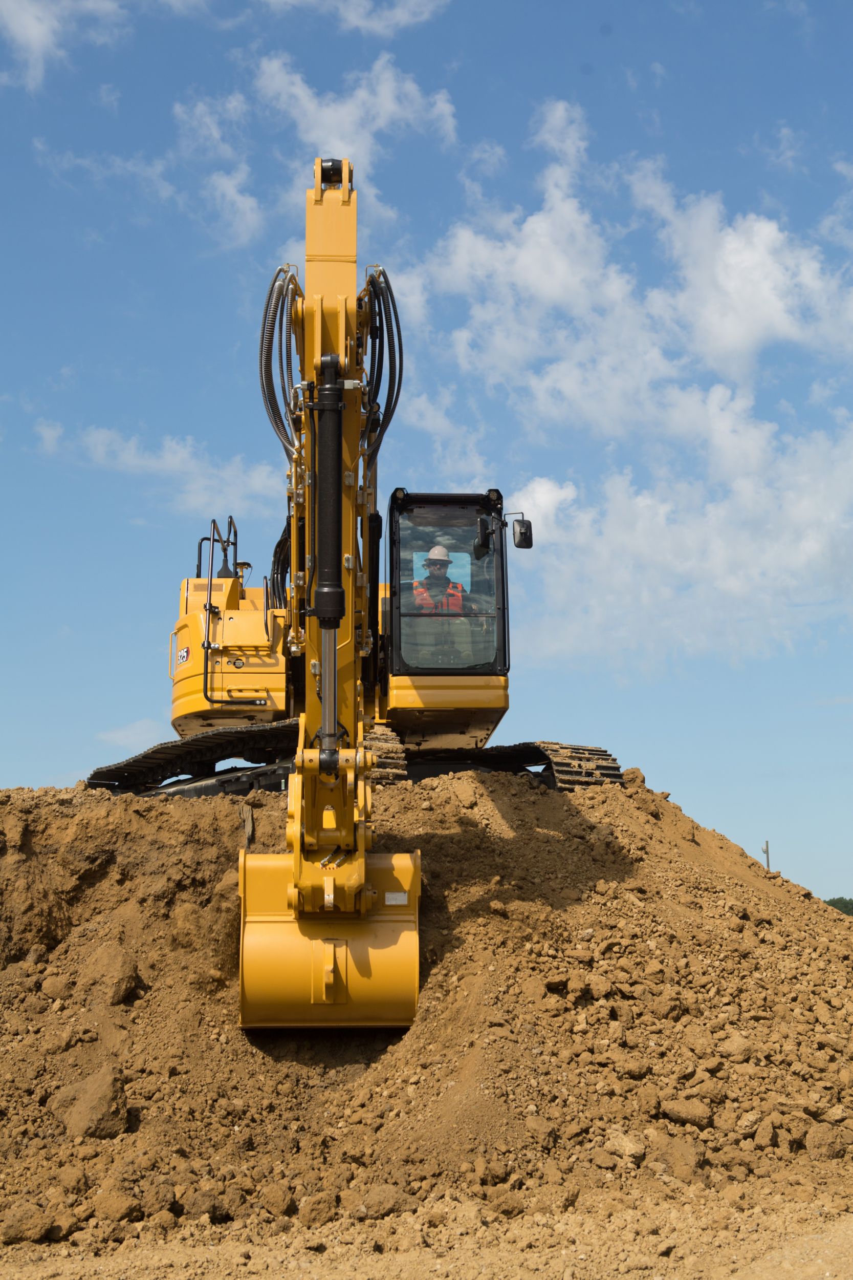 325 Hydraulic Excavator scooping dirt