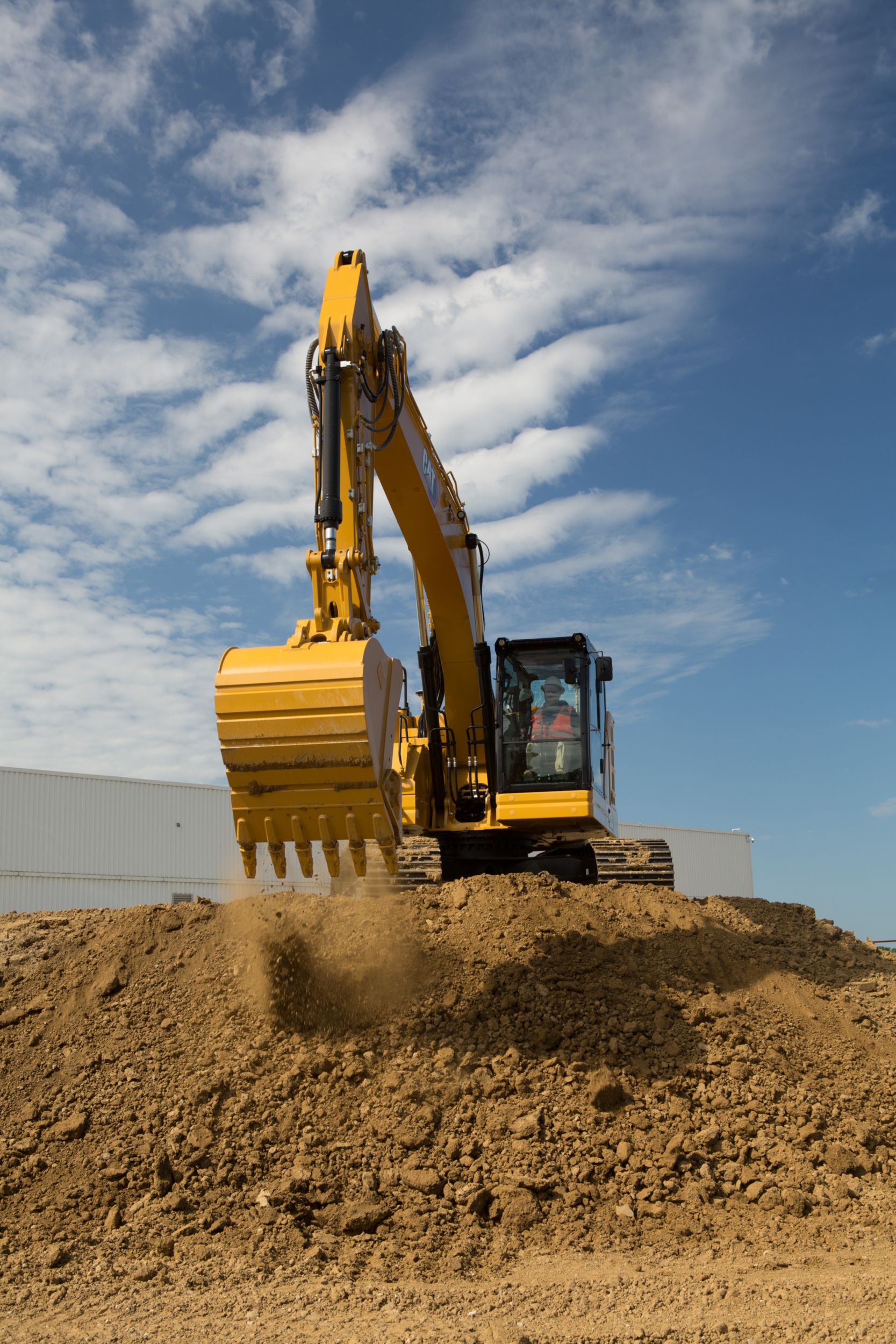 325 Hydraulic Excavator creating a dirt pad