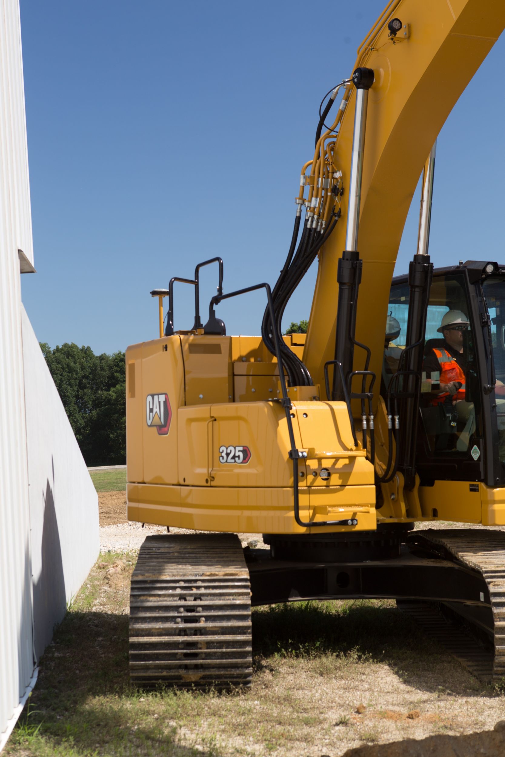 325 Hydraulic Excavator working close to a building structure