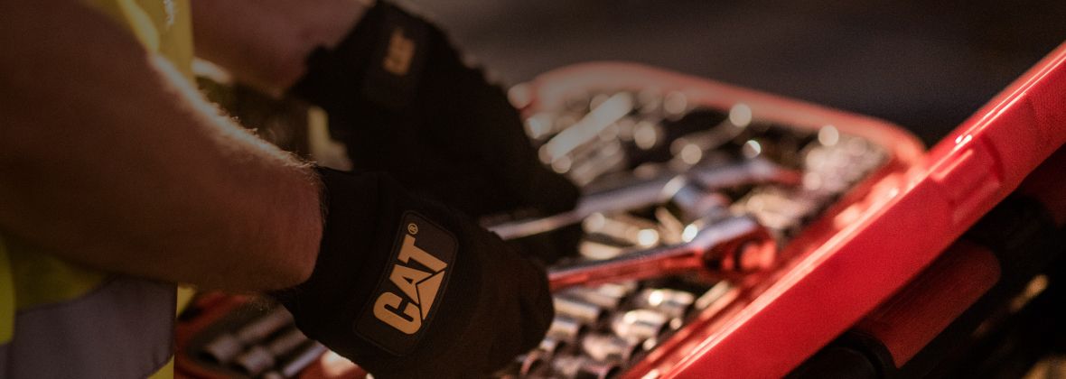 Operator choosing tools to service mini excavator