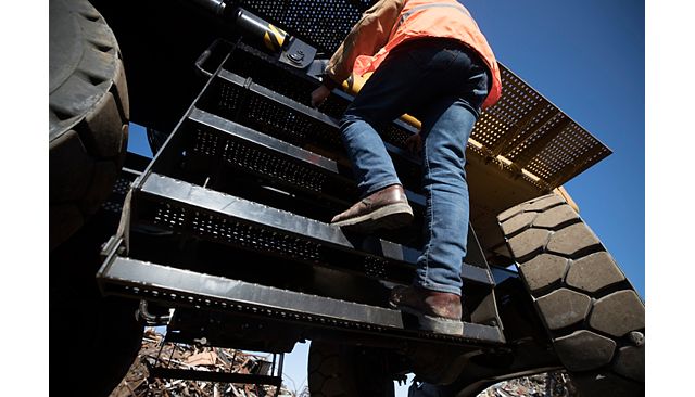 MH3040 operator using 3 points of contact going up anti-skid steps