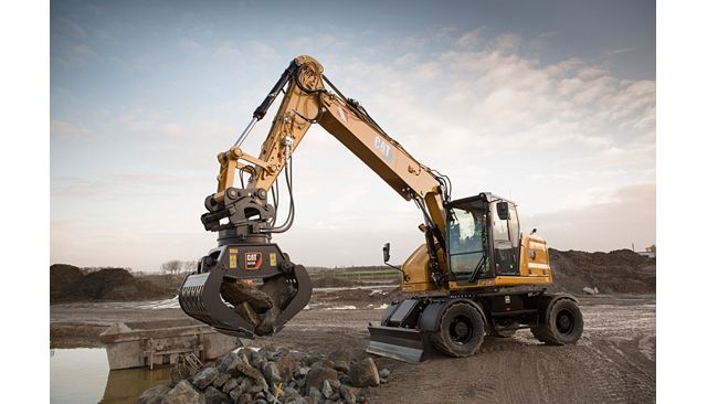 M318 using a grapple to move rock