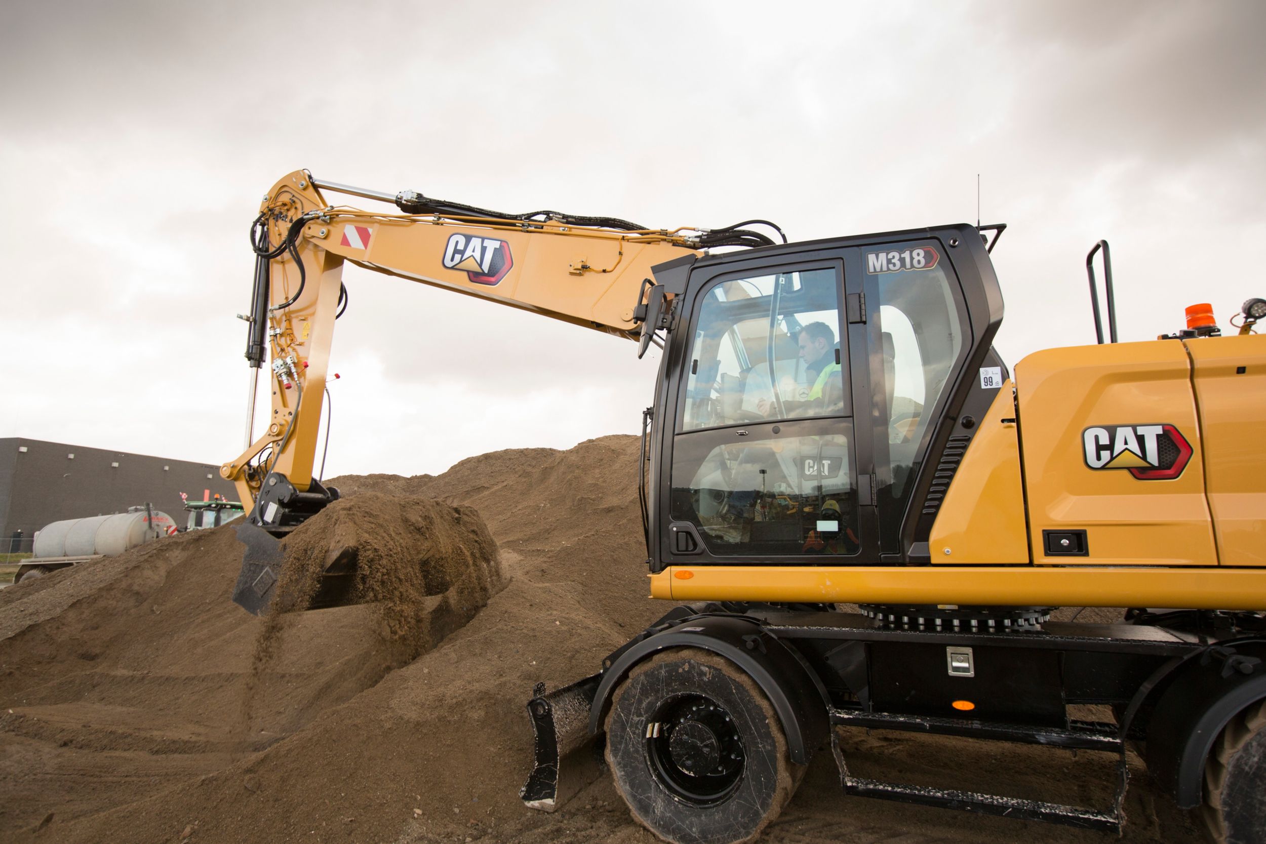 Quickly load trucks with the M318 Wheeled Excavator