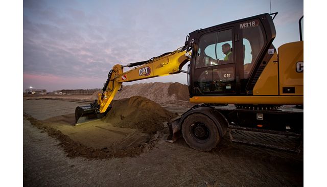 M318 operator looking comfortable in the cab while working