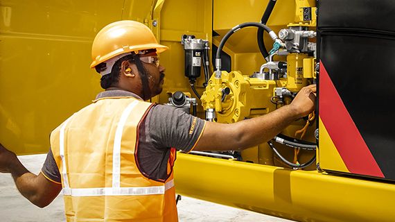 Technician working on equipment engine