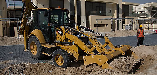 A wheel loader lifting a load of timber