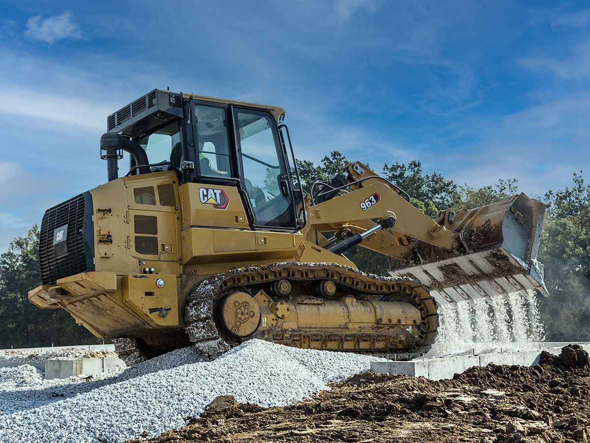 Use your Cat track loader to spread gravel around a foundation