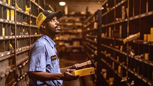 Dealer parts and service support team member finding parts