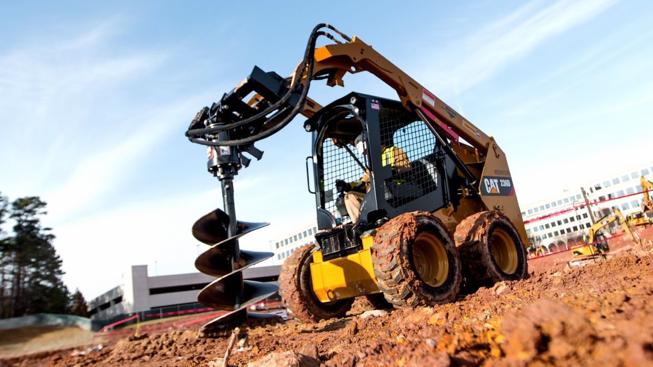 Skidsteer using work drill tool