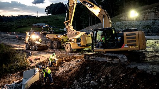 Equipment working on jobsite near dusk