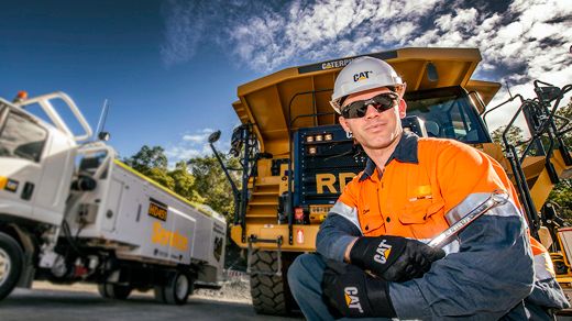 Older male customer sitting wearing Caterpillar branded hat during COVID-19 pandemic