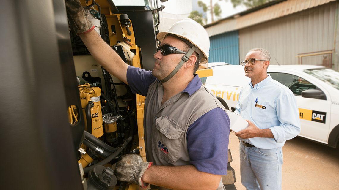 Two workers looking at plans