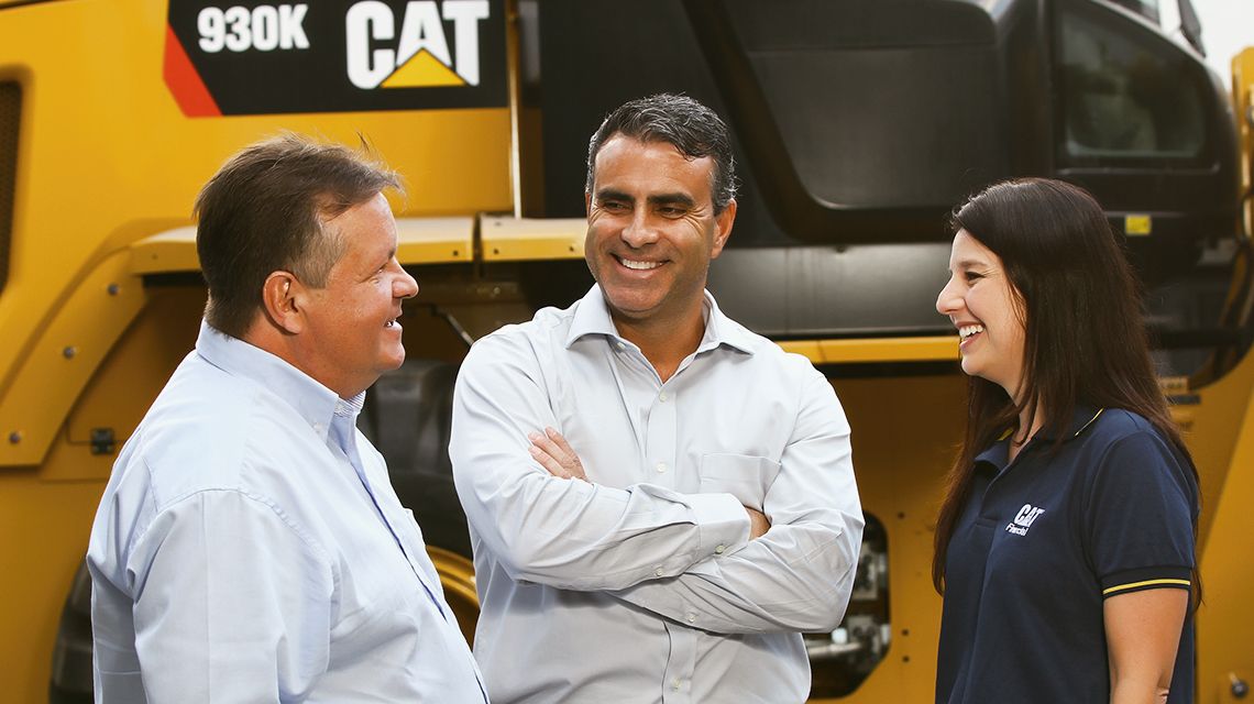 Two Caterpillar SME talking while seated