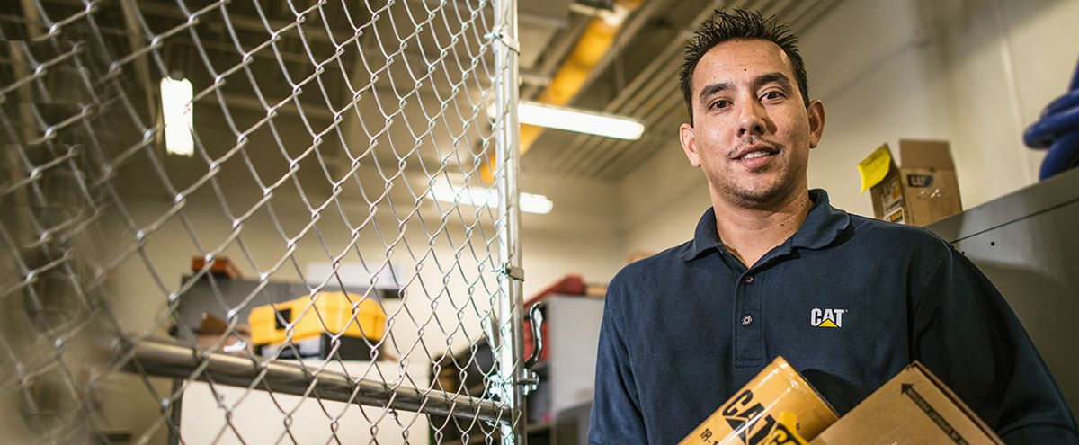 Cat dealer tech using computer to trouble shoot equipment issue