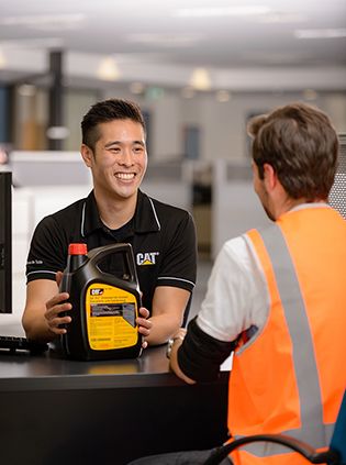 Cat dealer tech using computer to trouble shoot equipment issue