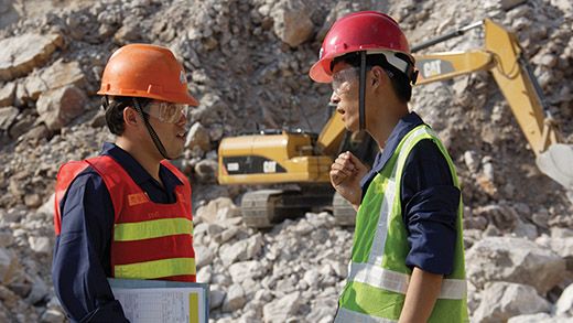 Cat dealer conversing with customer