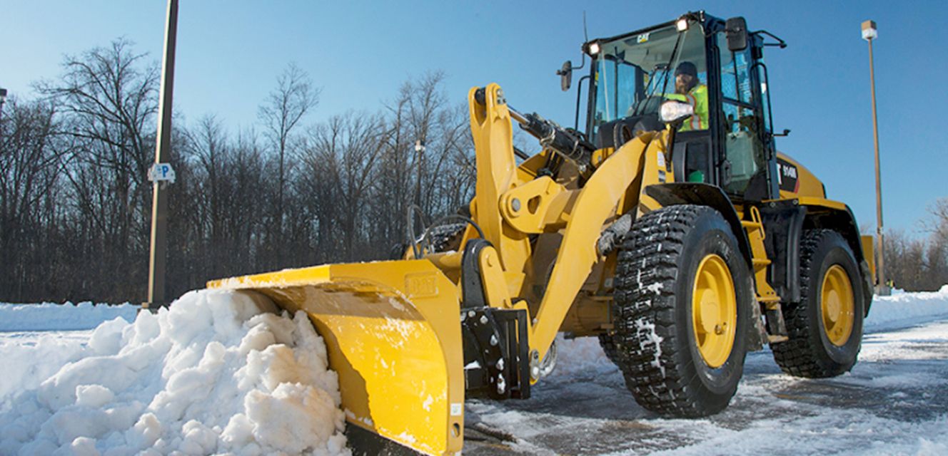 a wheel loader pushing snow