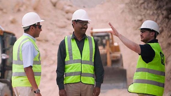 Older male customer sitting wearing Caterpillar branded hat during COVID-19 pandemic