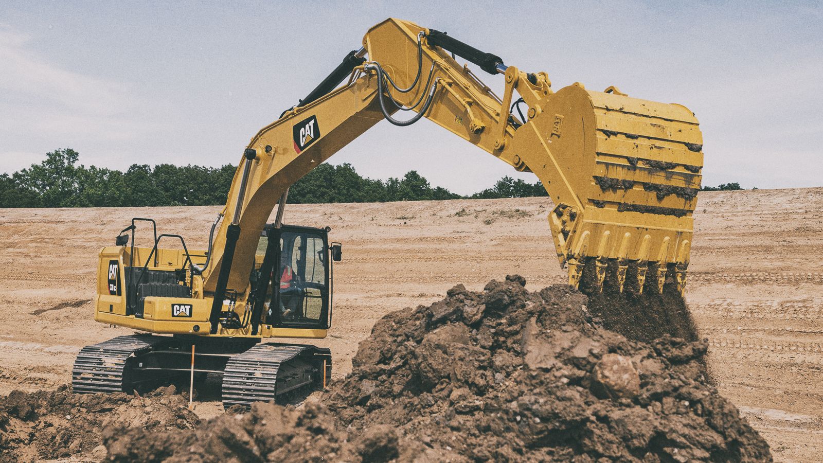 330 GC Excavator picking up dirt on jobsite